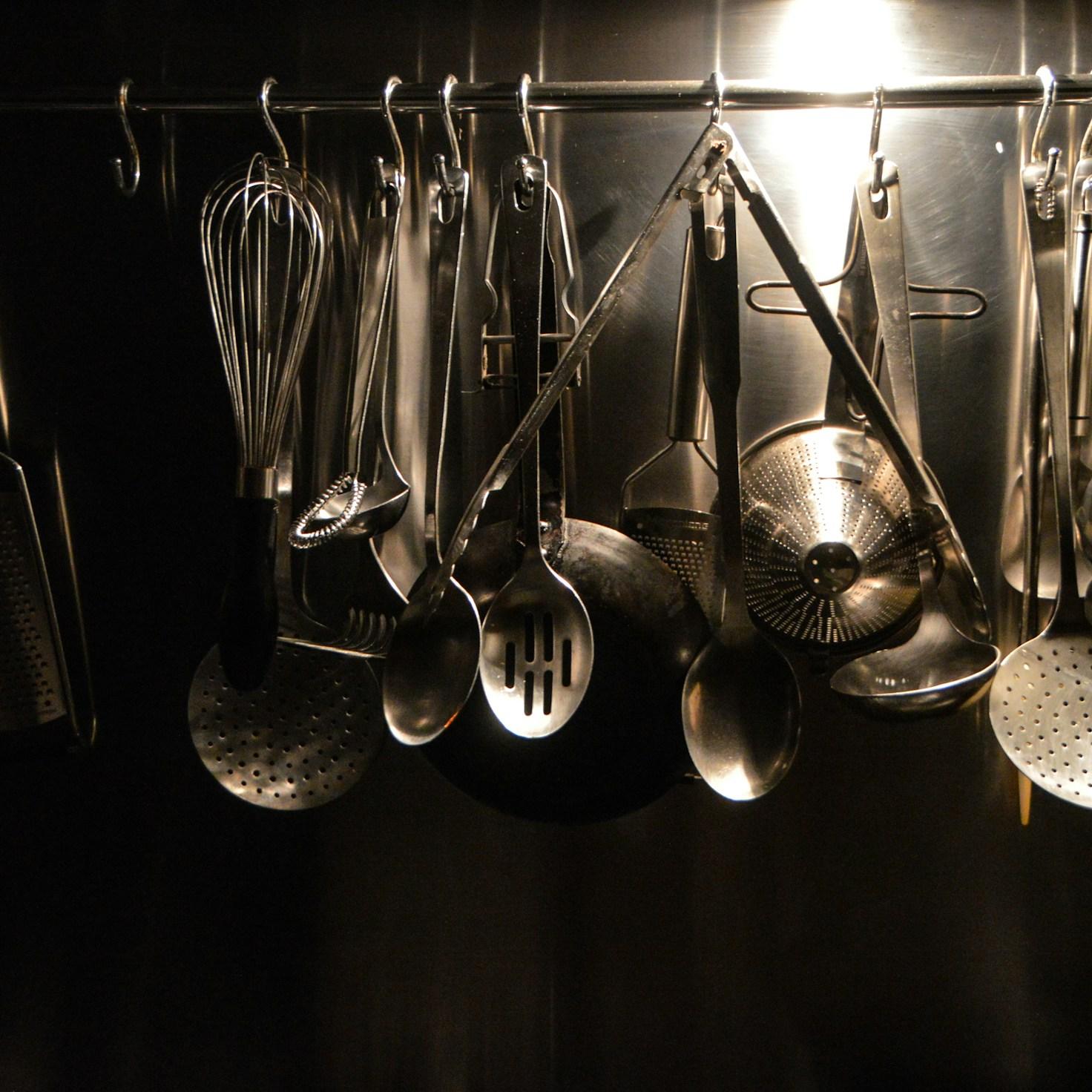 Community members collaborating in a modern kitchen, sharing recipes and techniques